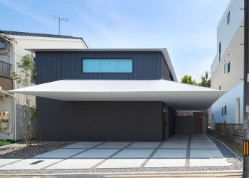 Floating slices of white bees via the black quantity of air residence by Airhouse in Japan
