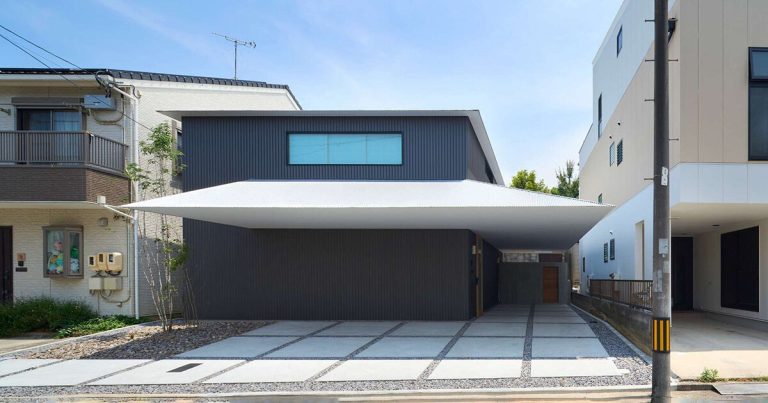 Floating slices of white bees via the black quantity of air residence by Airhouse in Japan
