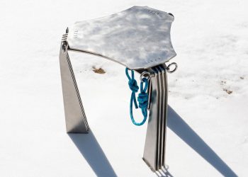 The “hanging” chair of metal with carabinie attracts the design from mountaineering