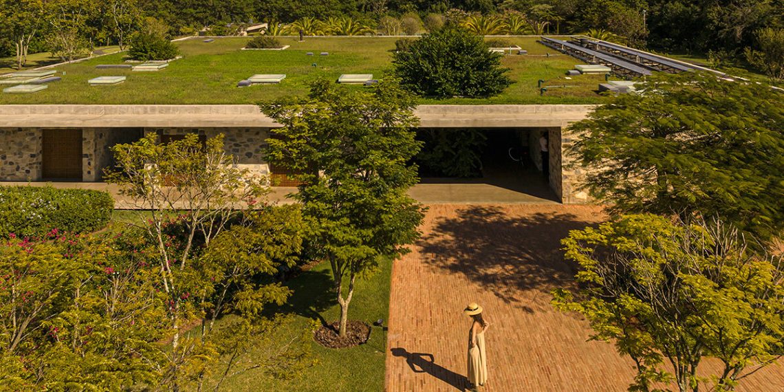 Stone volumes compose the MK27 studio residence underneath a steady overlap in São Paulo