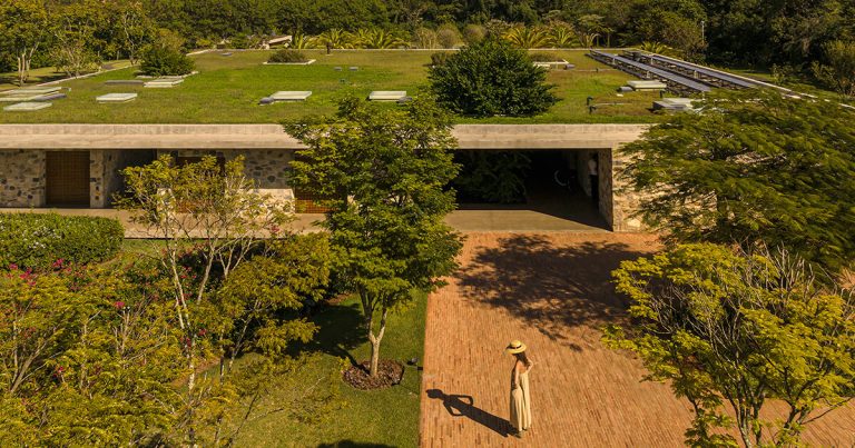 Stone volumes compose the MK27 studio residence underneath a steady overlap in São Paulo