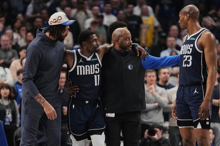 Mavericks ‘star Kyrie Irving, helped the ground after an uncomfortable knee damage at the start of the kings’ loss