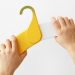 Foldable banner-shaped hanger helps youngsters to arrange their garments