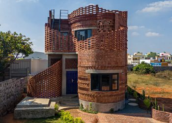 The home of company of brick flowing from artwork and spiral structure as a cactus below the Indian Solar