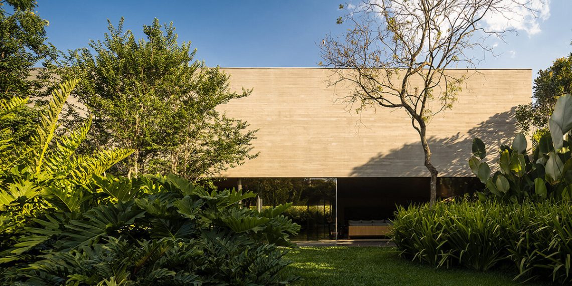 The monolithic concrete home of the MK27 studio is held on the tropical backyard of São Paulo