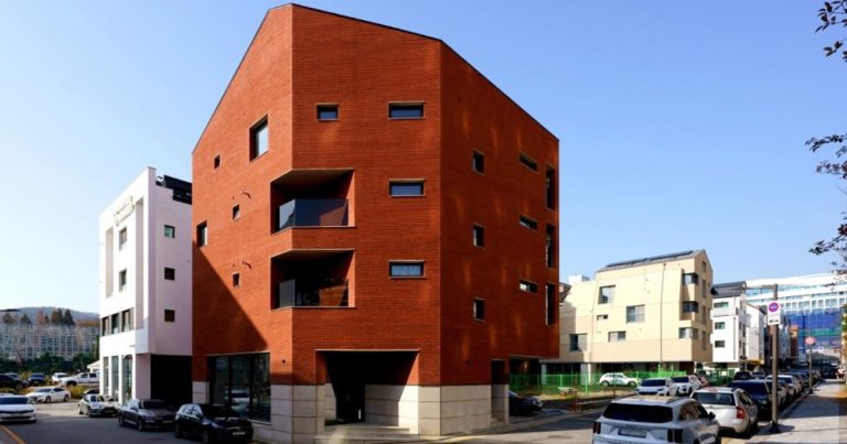 The crimson brick facade wraps the Cornerstone of LKSA housing unit in Korea