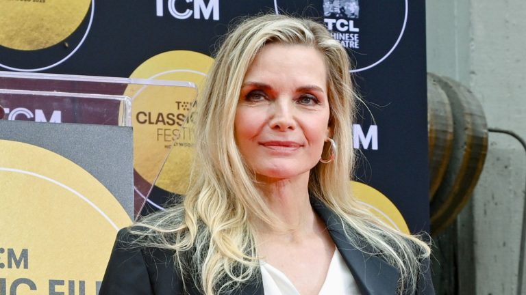Michelle Pfeiffer’s sapphire blue swimsuit and crystal-encrusted shades take poolside glamour to an entire new degree