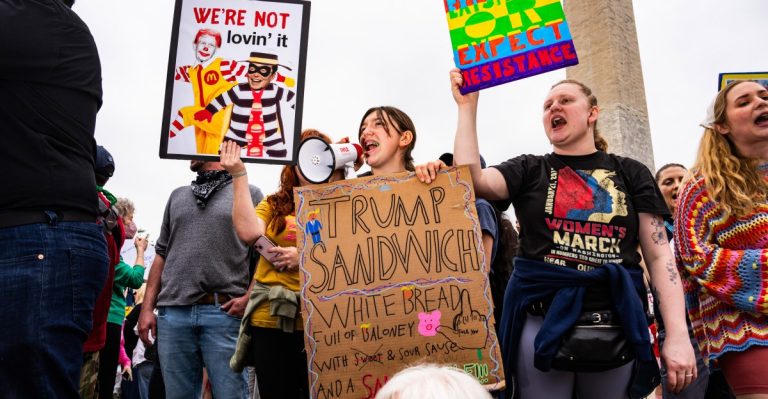 “Arms Off”: protesters ship an amazing Trump and Musk message to a DC rally