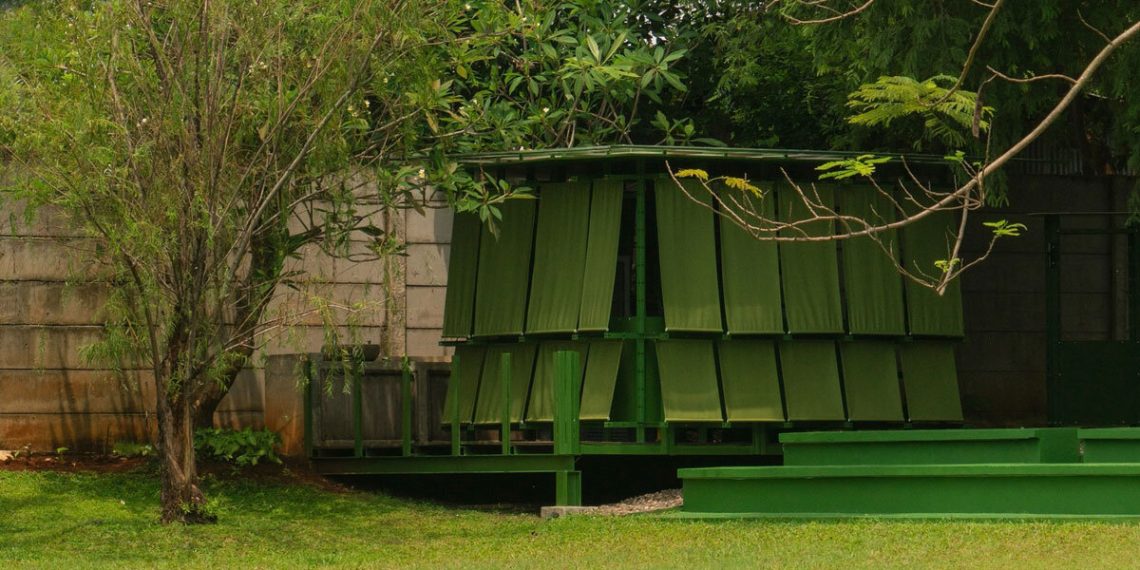 Modular metal grid and inexperienced material panels mannequin the momentary pavilion of dhaniē & sal