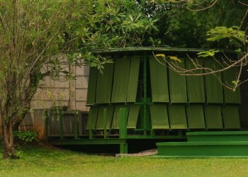 Modular metal grid and inexperienced material panels mannequin the momentary pavilion of dhaniē & sal