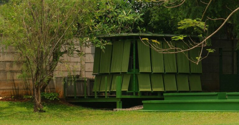 Modular metal grid and inexperienced material panels mannequin the momentary pavilion of dhaniē & sal