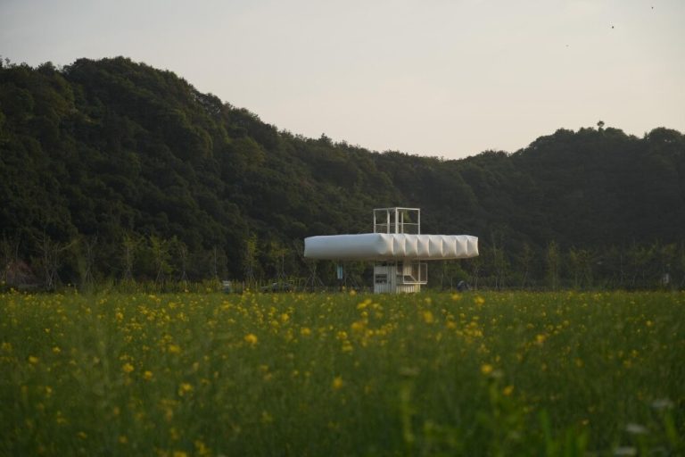 Trio of swollen pavilions creates rural cafe, cinema and library on the background of rice fields in China