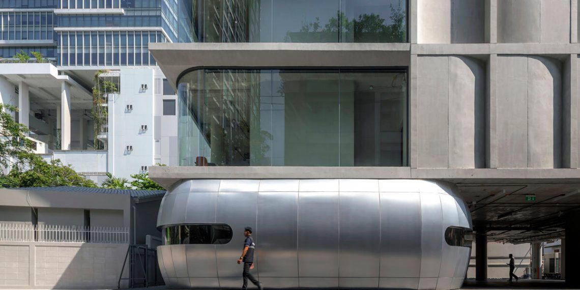 Convex and convex curved concrete panels form the facade of the Aswa constructing