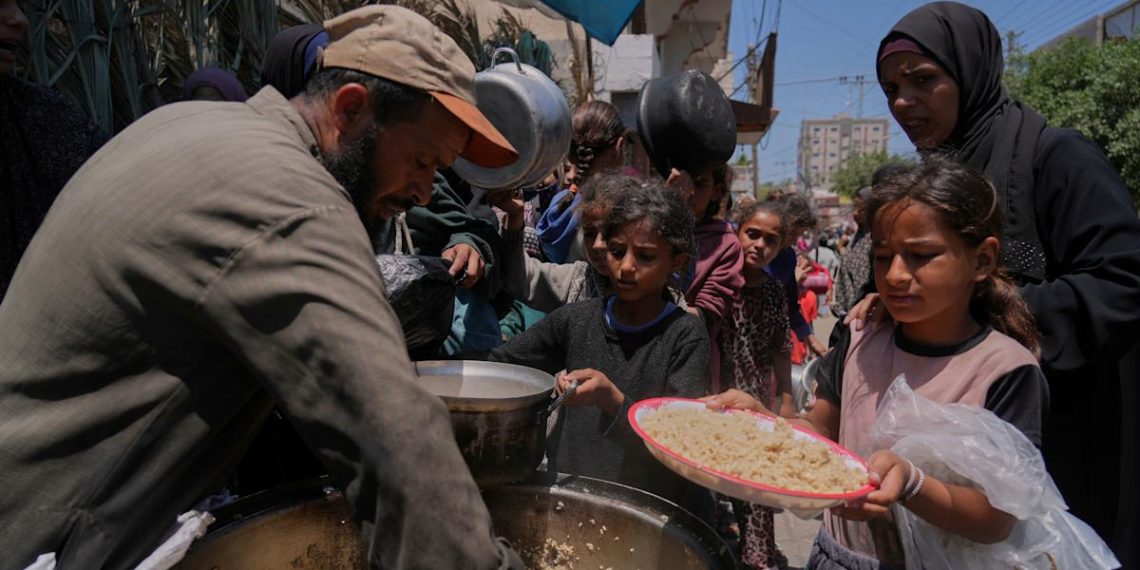 Palestinians block and empty dozens of UN meals lorries in Gaza Strip