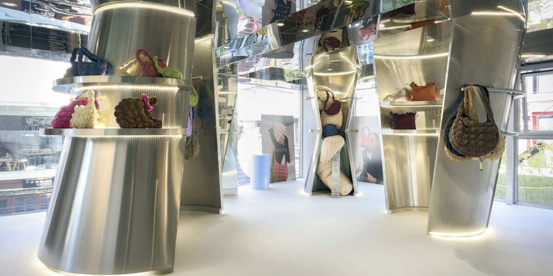 The reflective controls of curved inside metal of the Carlyn showroom in Seoul