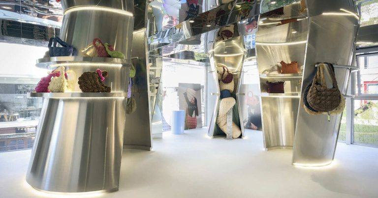 The reflective controls of curved inside metal of the Carlyn showroom in Seoul