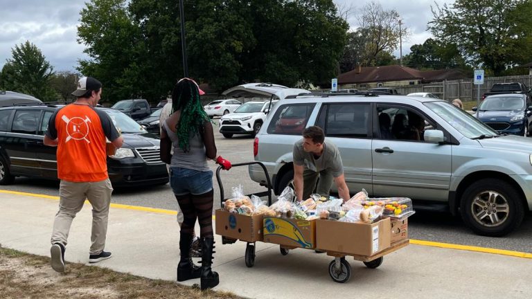 Wyoming college students handing out meals in cell pantry