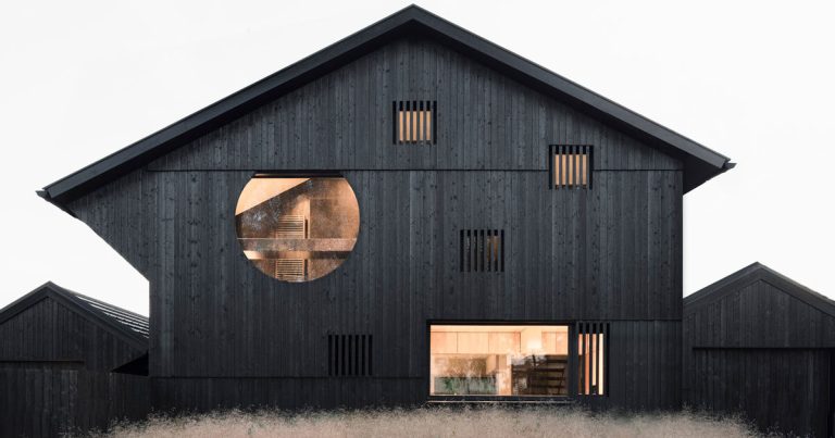 The plywood within the black carbonized timber wrapped twin homes with a single pillar