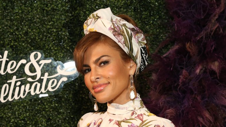 Eva Mendes nails Parisian styling in stylish navy costume and designer bag