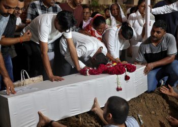 Members of the family participate within the funerals of the virtually 280 victims