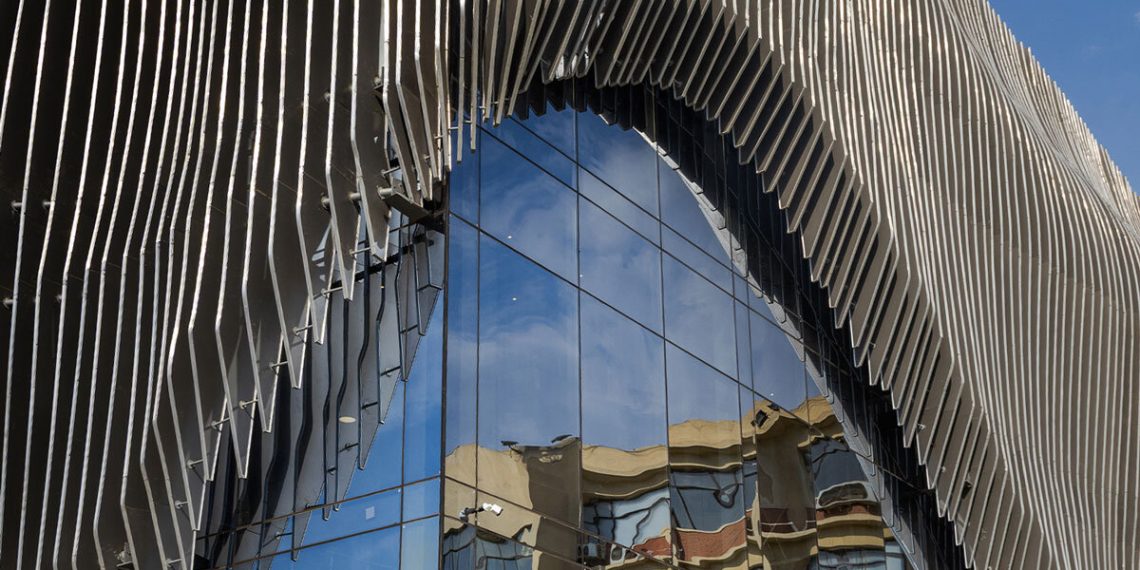 The facade of aluminum curtain wavy drapes over the Ain Shams College Theater in Egypt