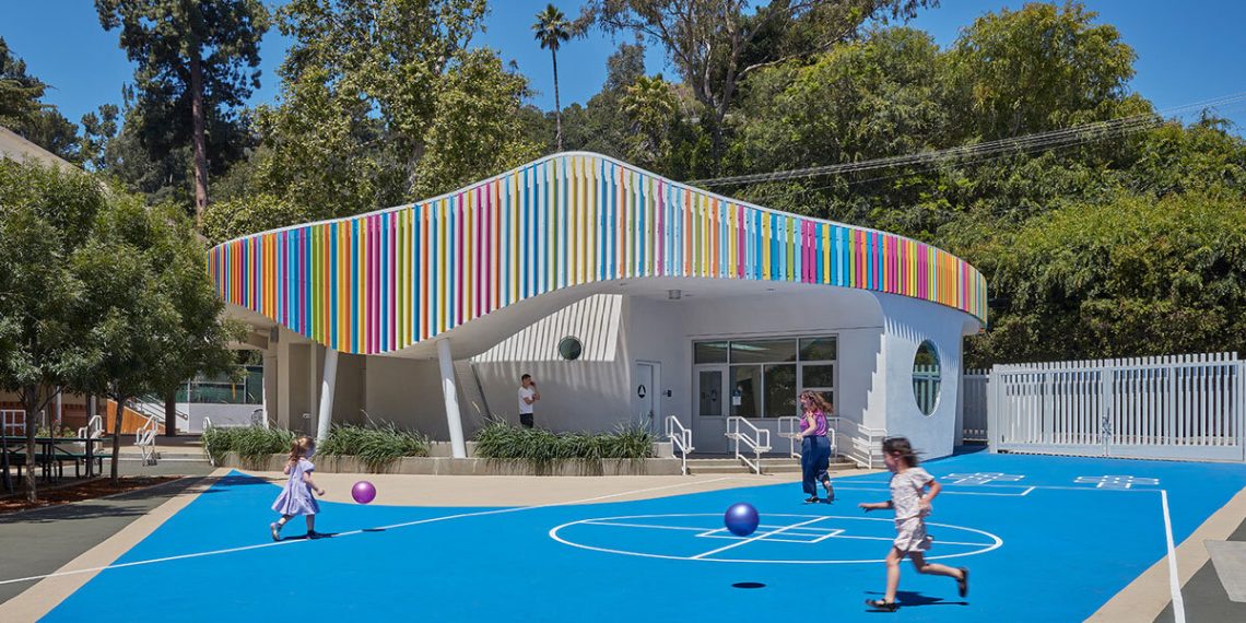 Louvers colourful is wrapped across the curved exterior of the elementary faculty in Los Angeles by Jfak
