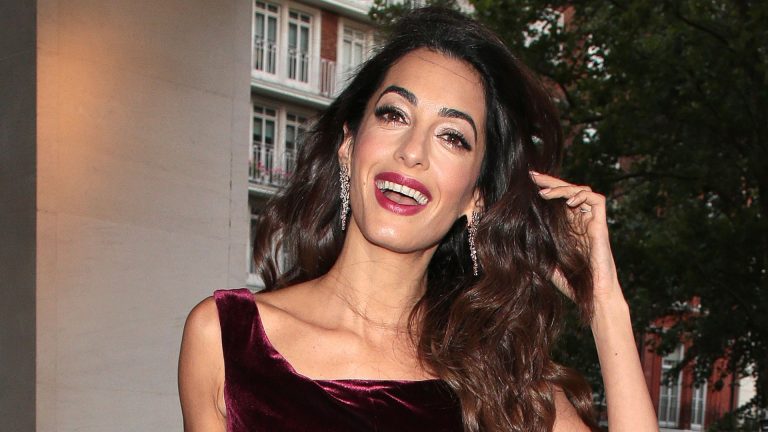 Amal Clooney’s burgundy jumpsuit is a perfect wedding ceremony visitor outfit