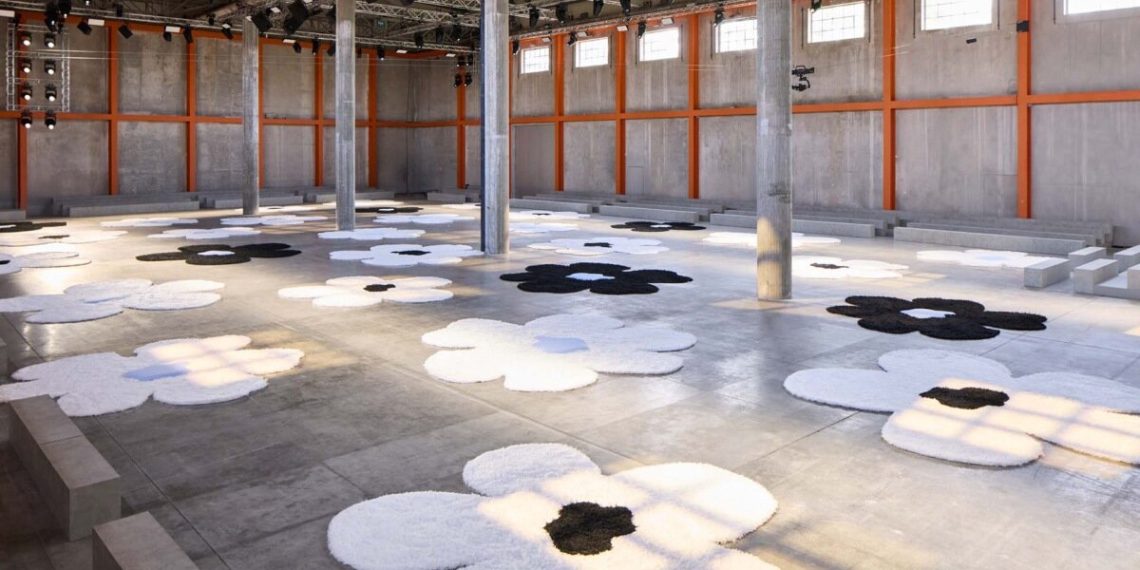 The islands of carpets with oma flowers at Prada SS26 Menwear Showcase