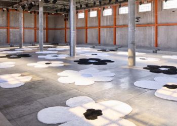 The islands of carpets with oma flowers at Prada SS26 Menwear Showcase