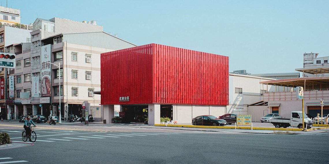 Pink steel panels surrounding a fiery facade for Taiwanese de Paperfarm restaurant
